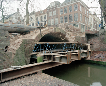 838564 Gezicht op de Paulusbrug over de Nieuwegracht te Utrecht, die gerestaureerd wordt.